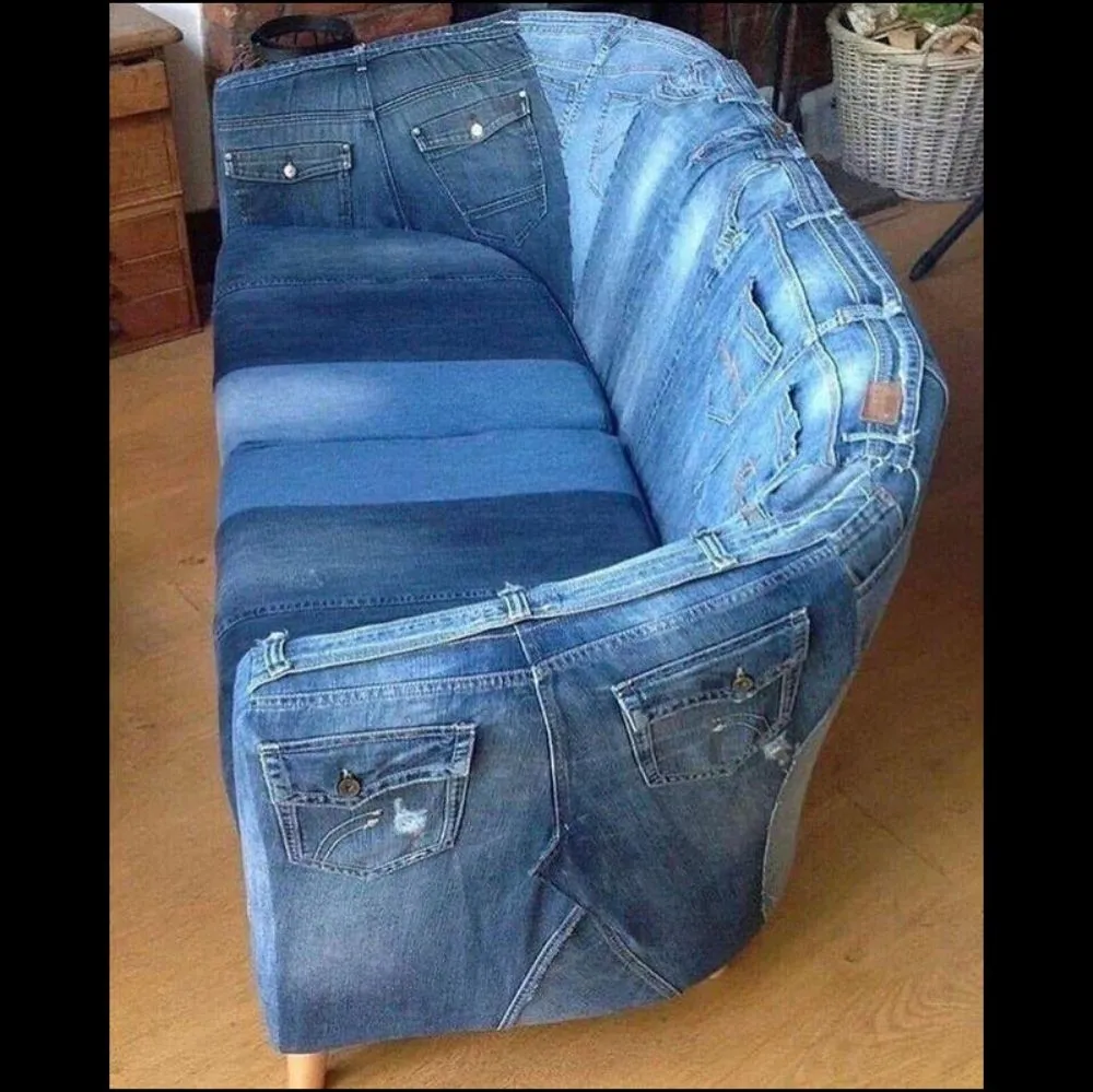 Person upholsters couch with blue jeans