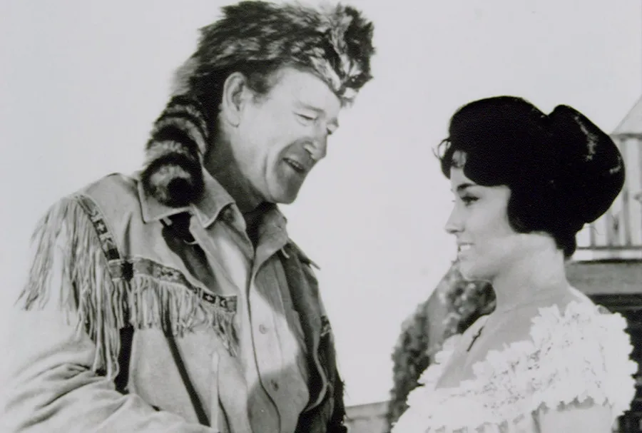 Argentine-American actress Linda Cristal with American actor and director John Wayne on the set of his movie The Alamo