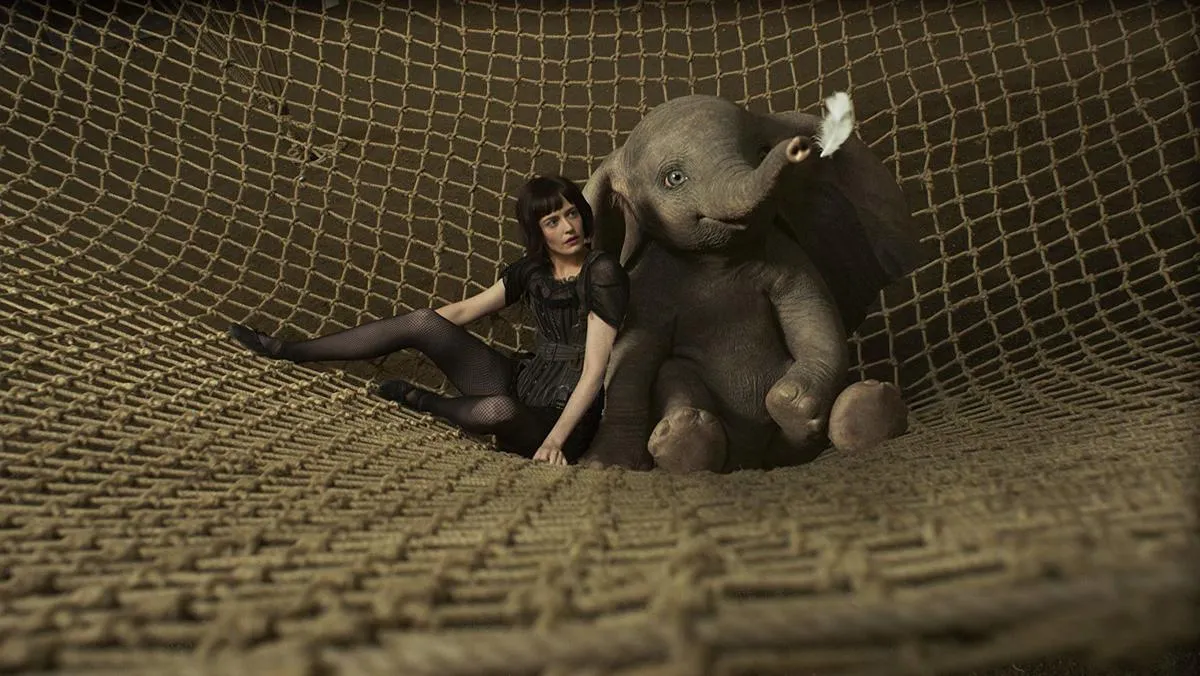 eva green sitting in a net with a cgi dumbo