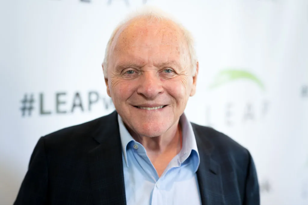 An aged Anthony Hopkins smiles at an event.