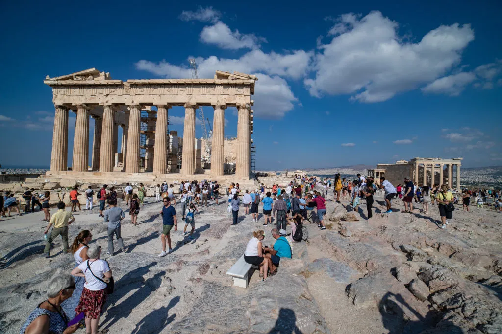 Tourists visit the Parthenon in Greece.