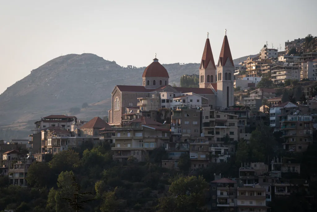 A hillside in Lebanon is full of homes surrounding a grand cathedral.