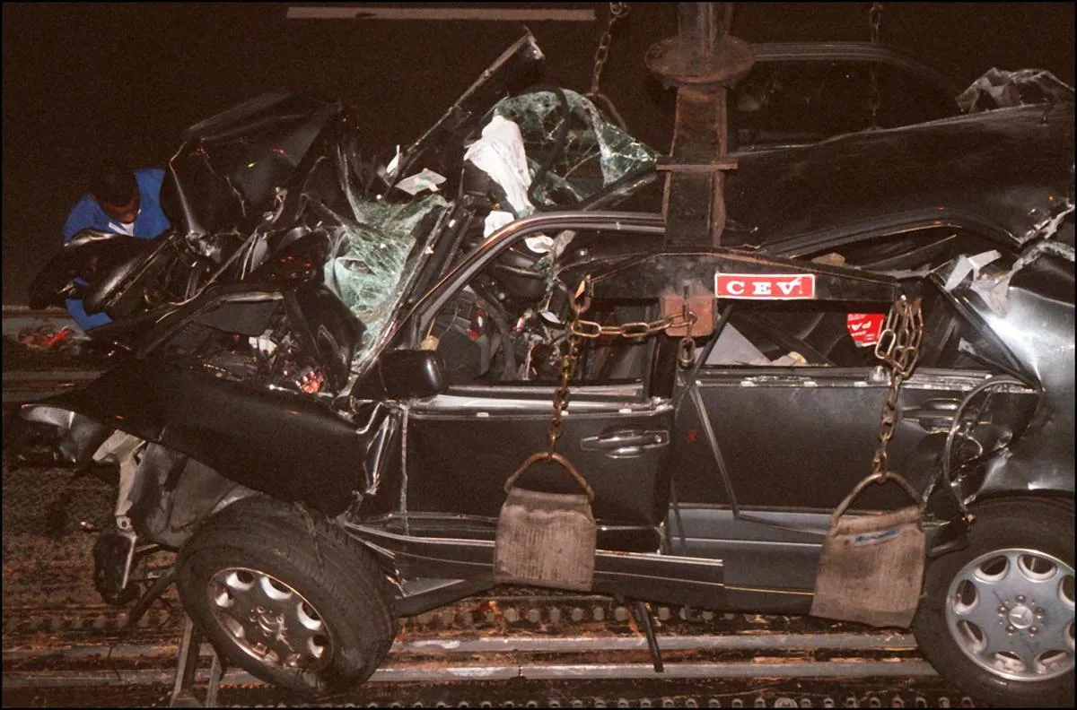 A French policeman attaches the wreckage of Princess Diana's car 31 August in the Alma tunnel of Paris.