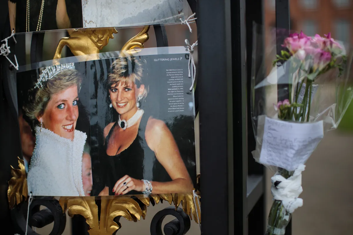 Floral tributes, photographs and messages sit on an entrance gate to Kensington Palace honor the 20th anniversary of the death of Diana.