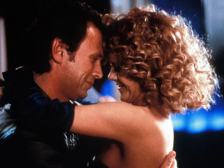 Harry and Sally smile and embrace.