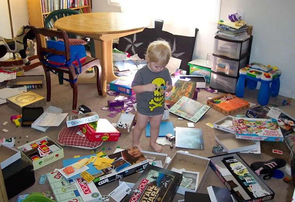 child makes mess with board games