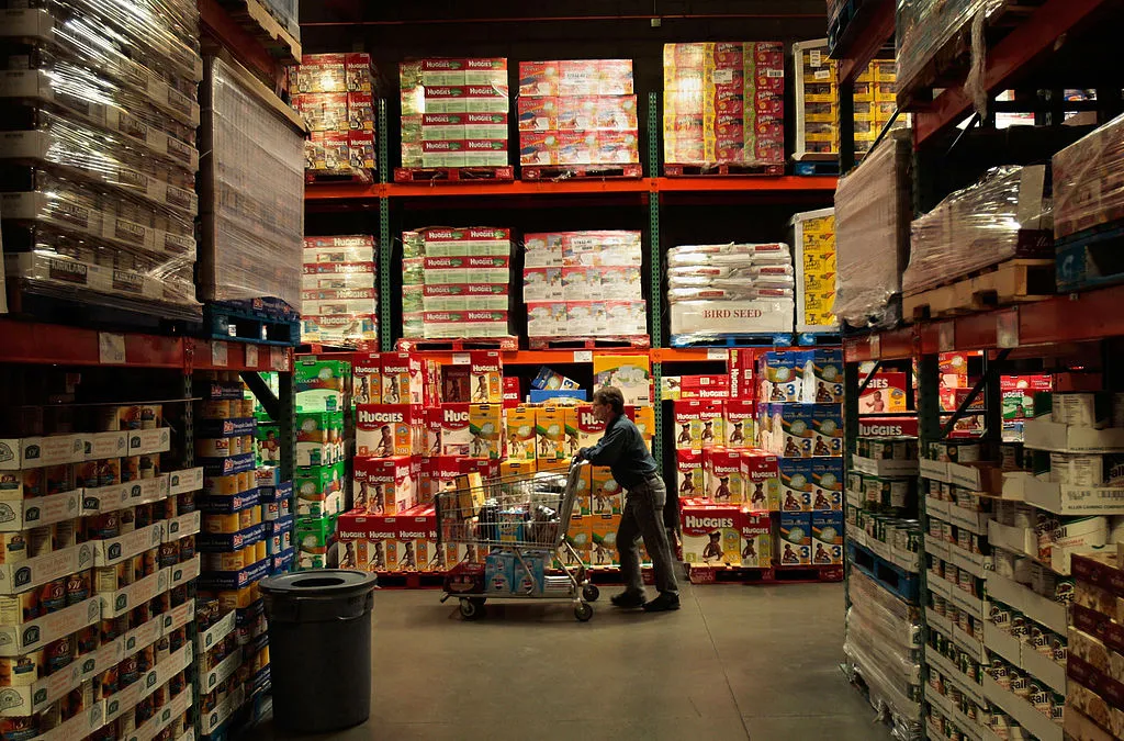 A shopper pushes a cart through the aisles of a Costco store