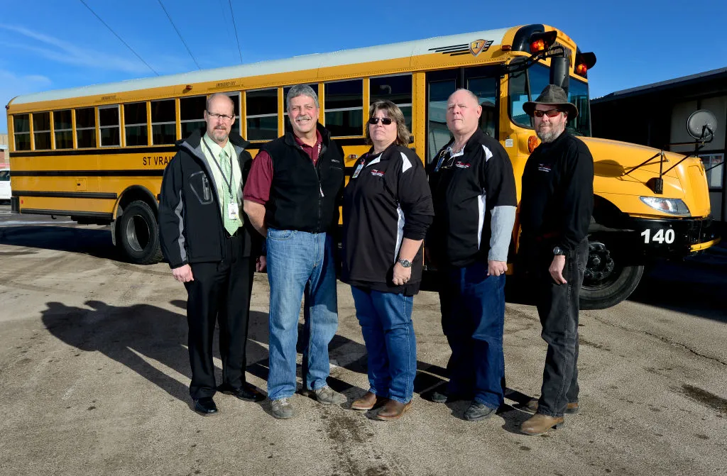 school bus drivers posing for a picture