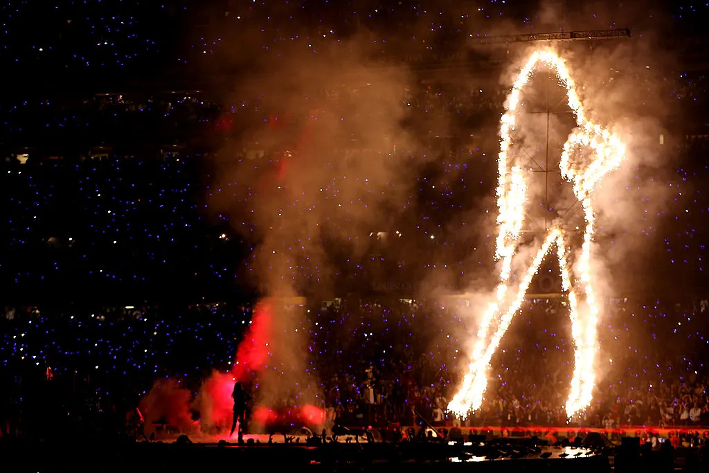 A giant, lit-up outline of a woman sets the stage for Beyonce's 2013 Super Bowl performance.