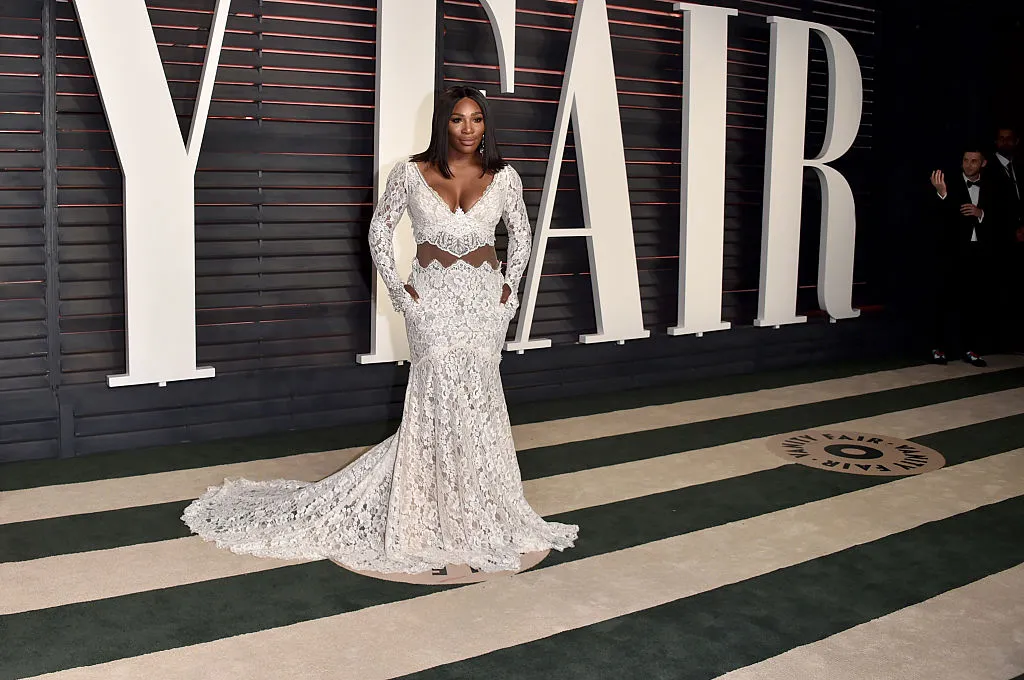 Serena poses in a patterned, white gown.