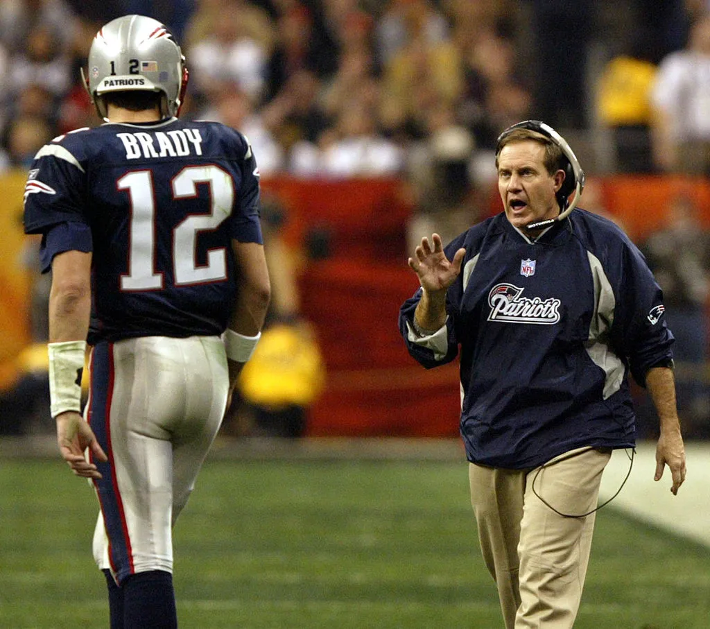 Patriots head coach Bill Belichick, right, gives some instructions to quarterback Tom Brady
