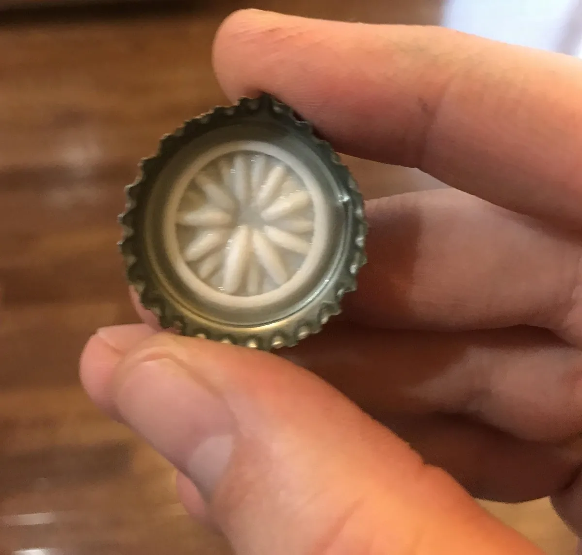 the purpose of the bottom of a bottle cap