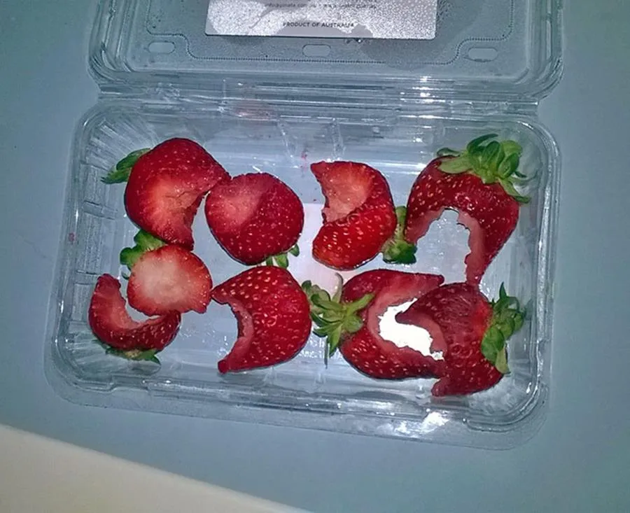 strawberries in carton with bites taken out