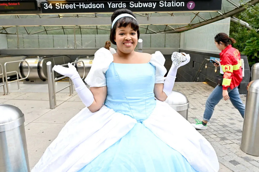a woman outside a subway station dressed as cinderella