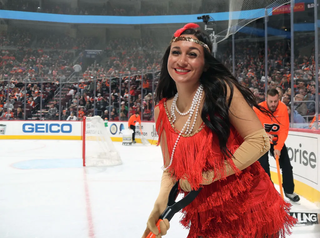 a woman dressed as a flapper at an ice hockey game