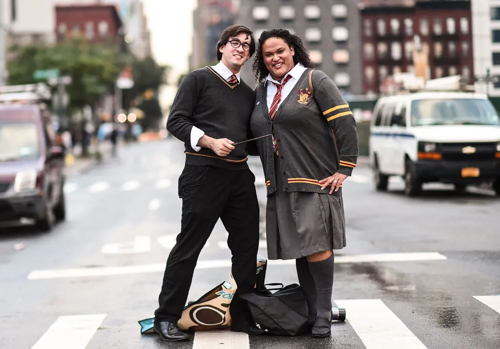 a couple dressed as harry potter and hermoine granger
