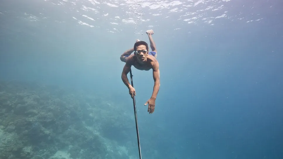 Will Millard swims with a spear during the show Hunters of the South Seas.