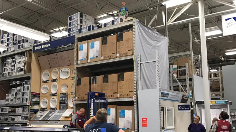 kid on top of store aisles