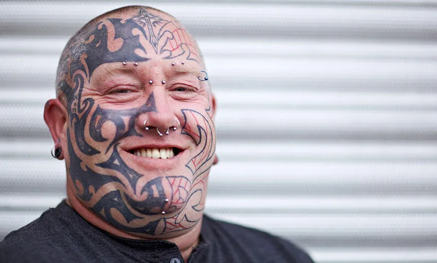 A man with facial tattoos is seen.