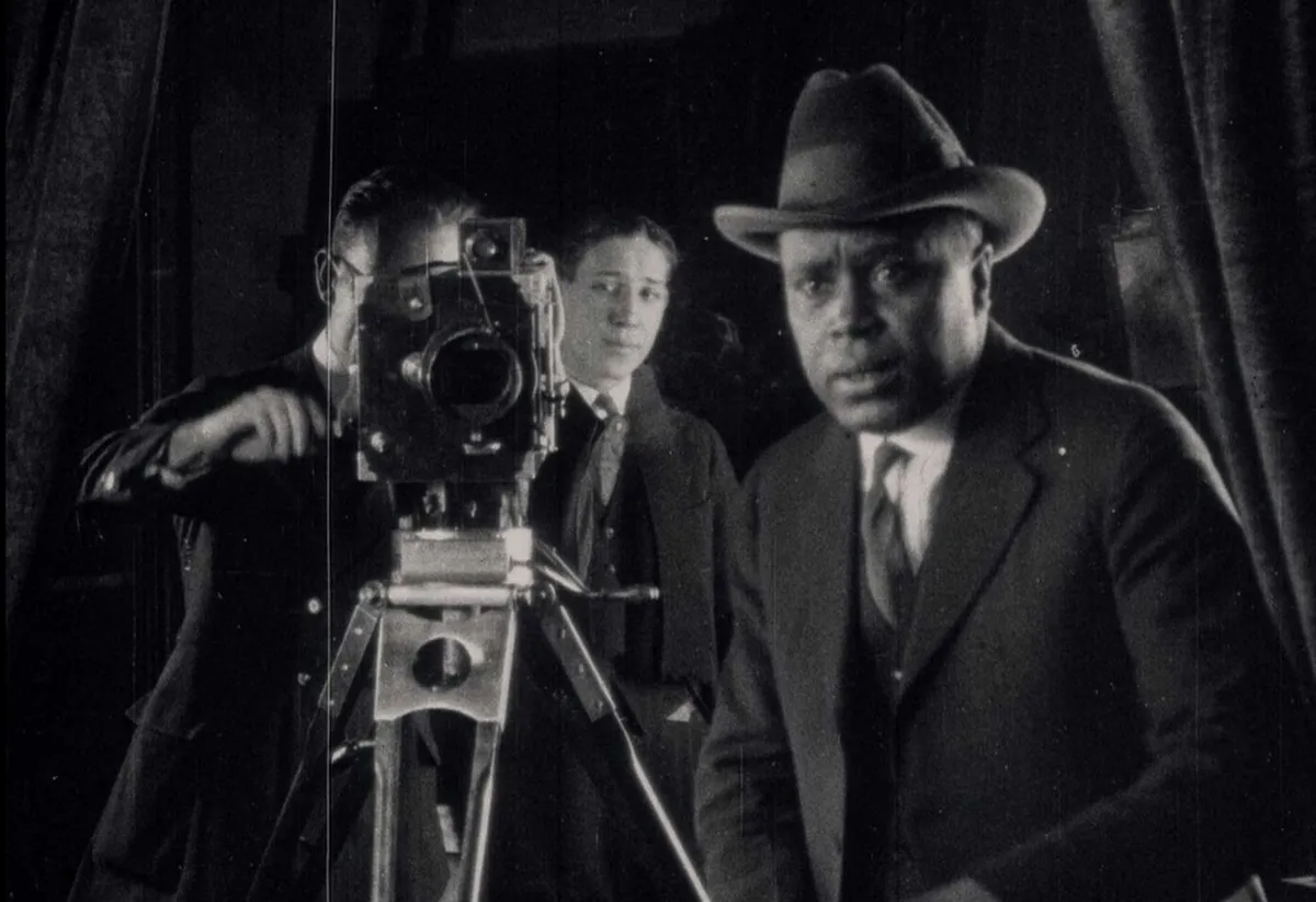 A director and cameramen are seen in a black-and-white photograph.