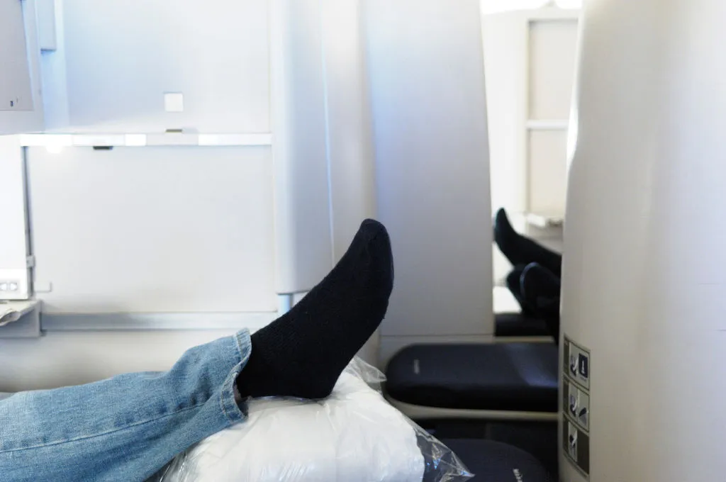 a close-up of someone wearing socks on an airplane