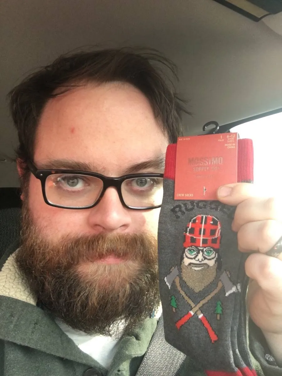 man with socks that have drawing of person that looks just like him