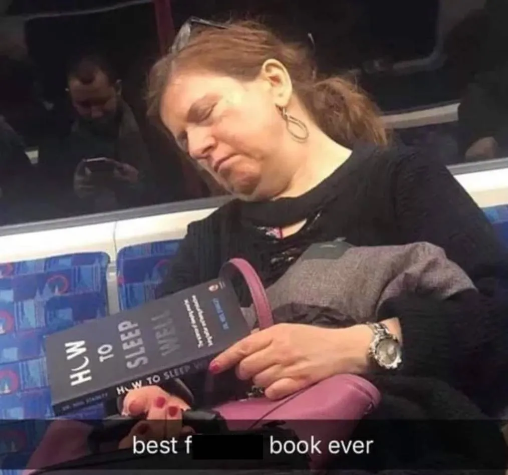 woman sleeping on bus holding book titled 
