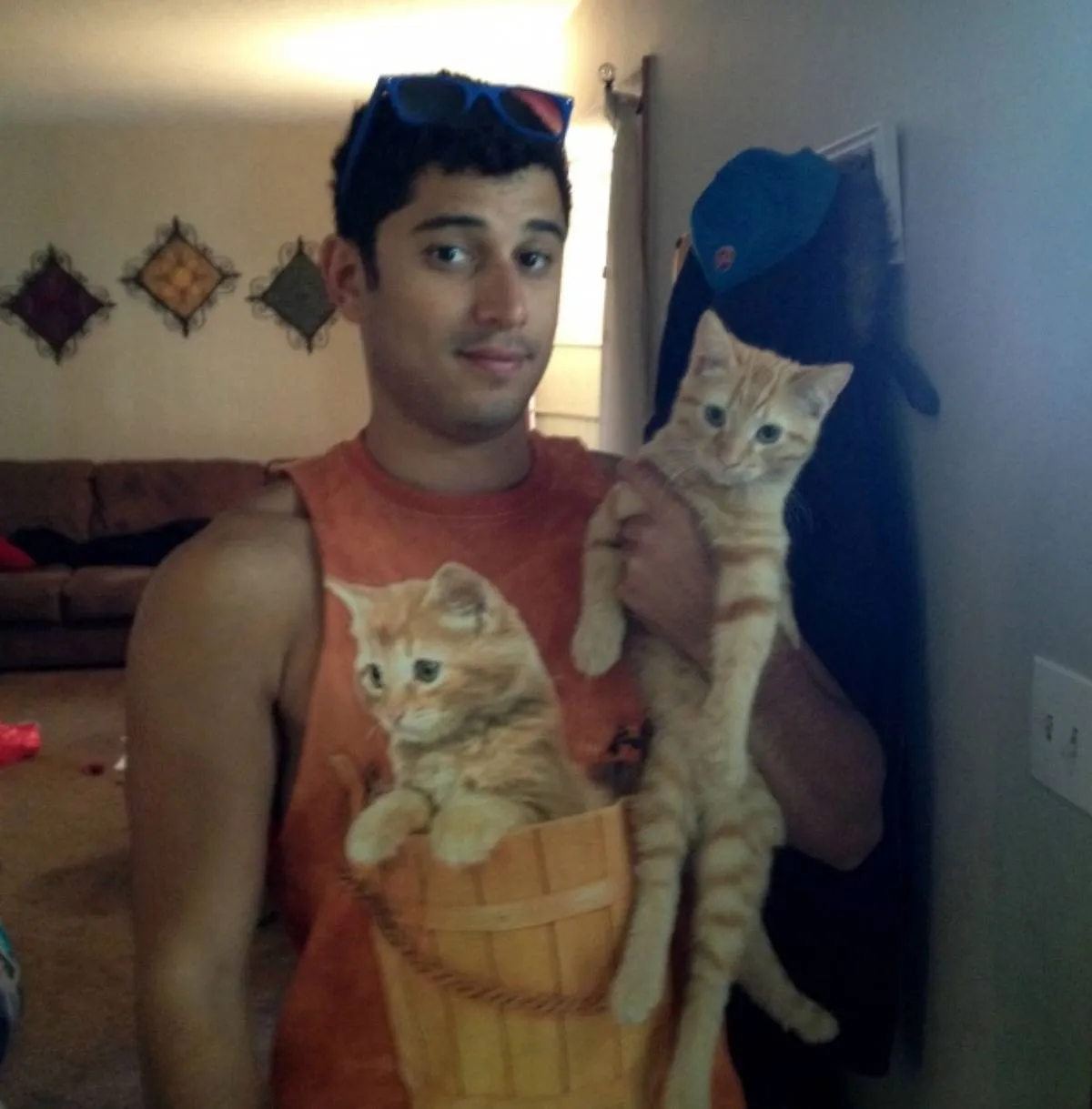 man with cat on his shirt holds cat that's identical to it