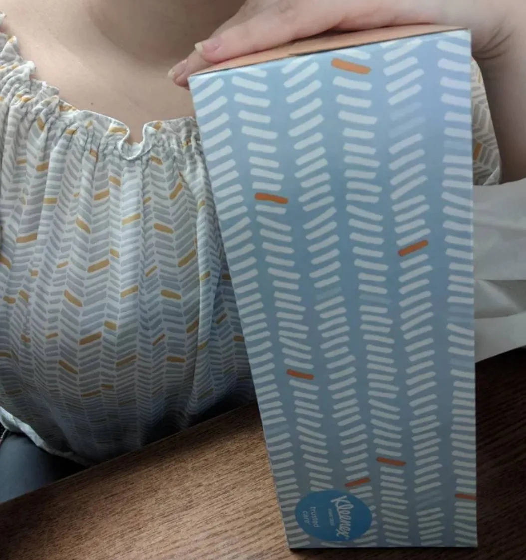 woman's shirt matches pattern on kleenex box