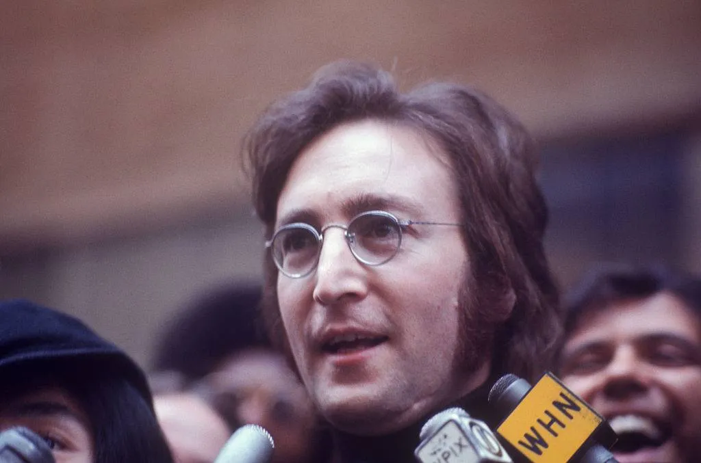 John Lennon being interviewed on the street.; circa 1970;