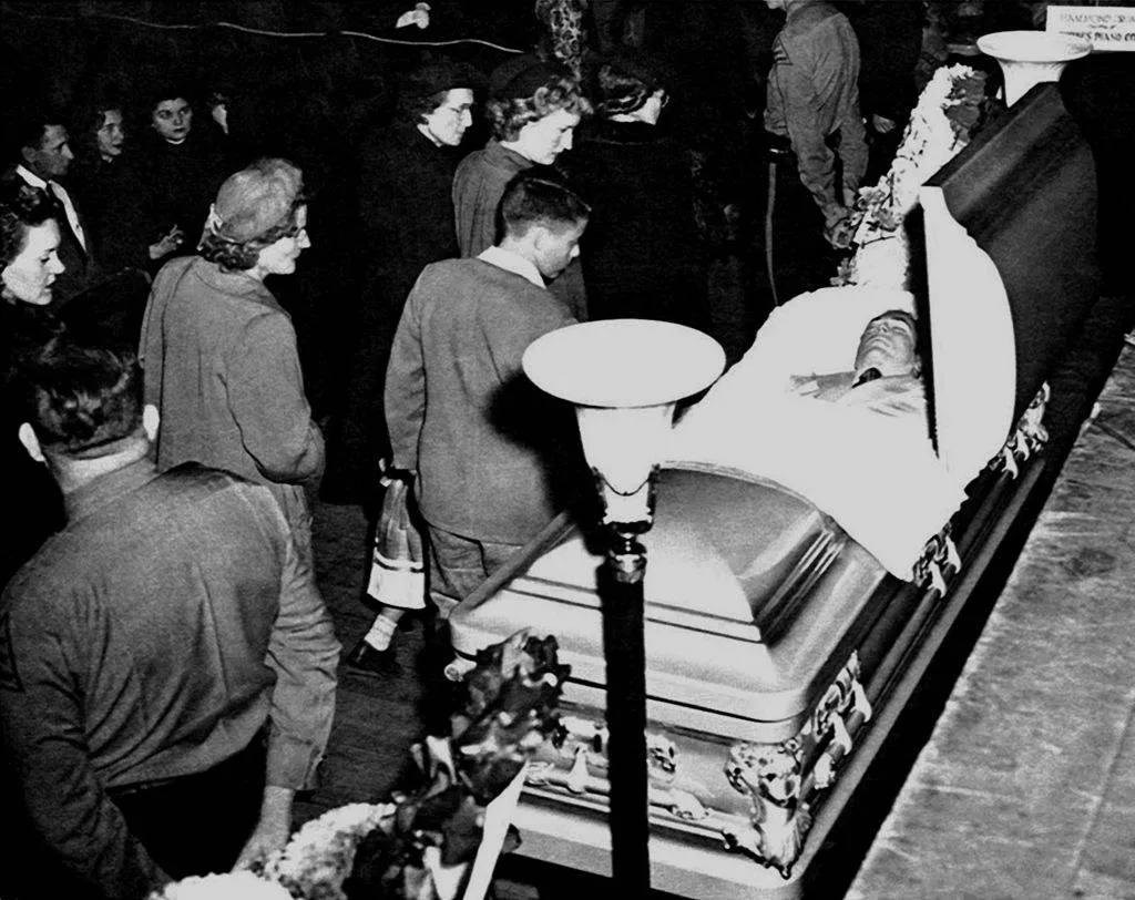 Mourners pass by the coffin containing the body of country singer Hank Williams