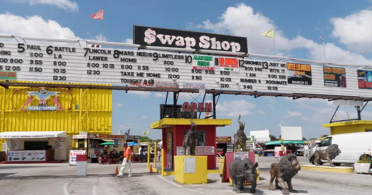 the front of a swap shop with a large sign with prices and a ticket booth