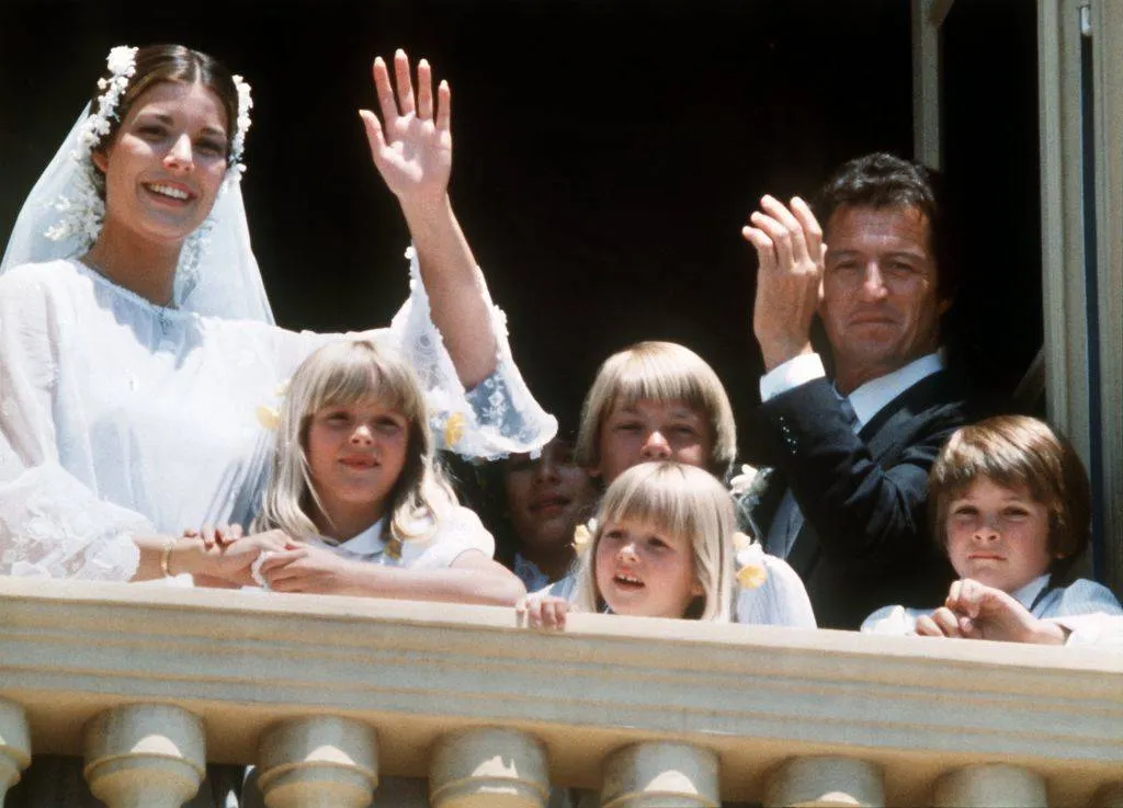 With a happy smile Princess Caroline of Monaco and her husband Philippe Junot wave to the public from the balcony