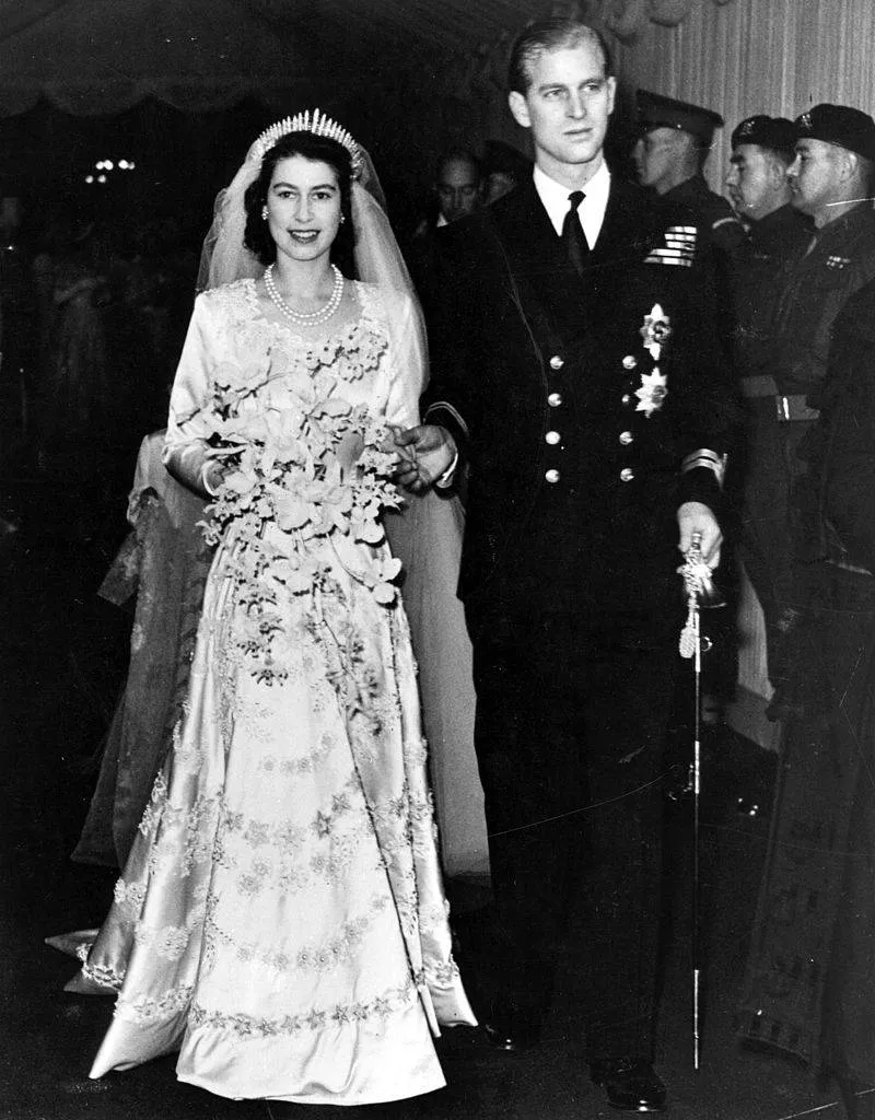 Queen Elizabeth II, as Princess Elizabeth, and her husband the Duke of Edinburgh, styled Prince Philip in 1957, on their wedding day. She became queen on her father King George VI's death in 1952.