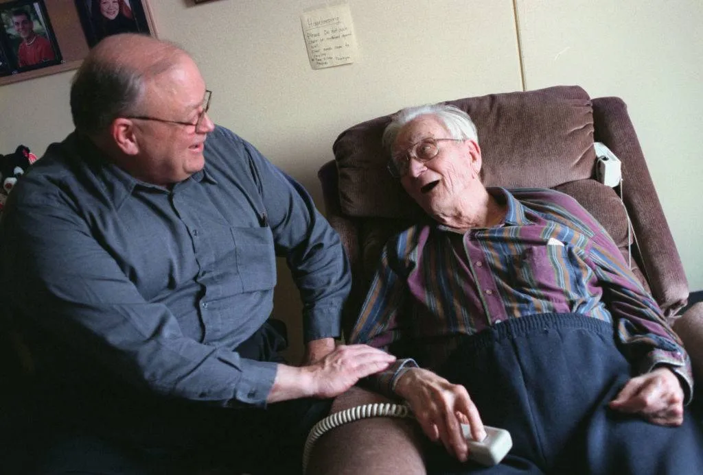 A man visits his father at a nursing home.