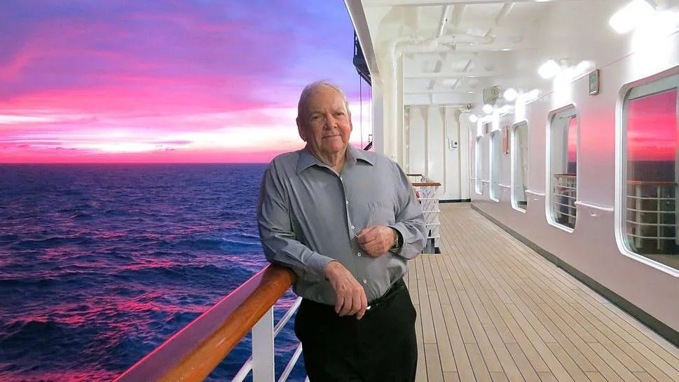 A man poses on a cruise ship.