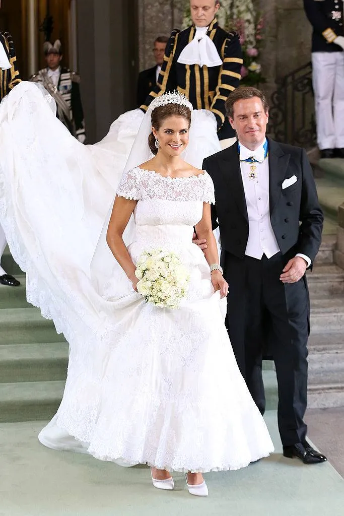 Princess Madeleine of Sweden and Christopher O'Neill smile at well wishers following their marriage ceremony