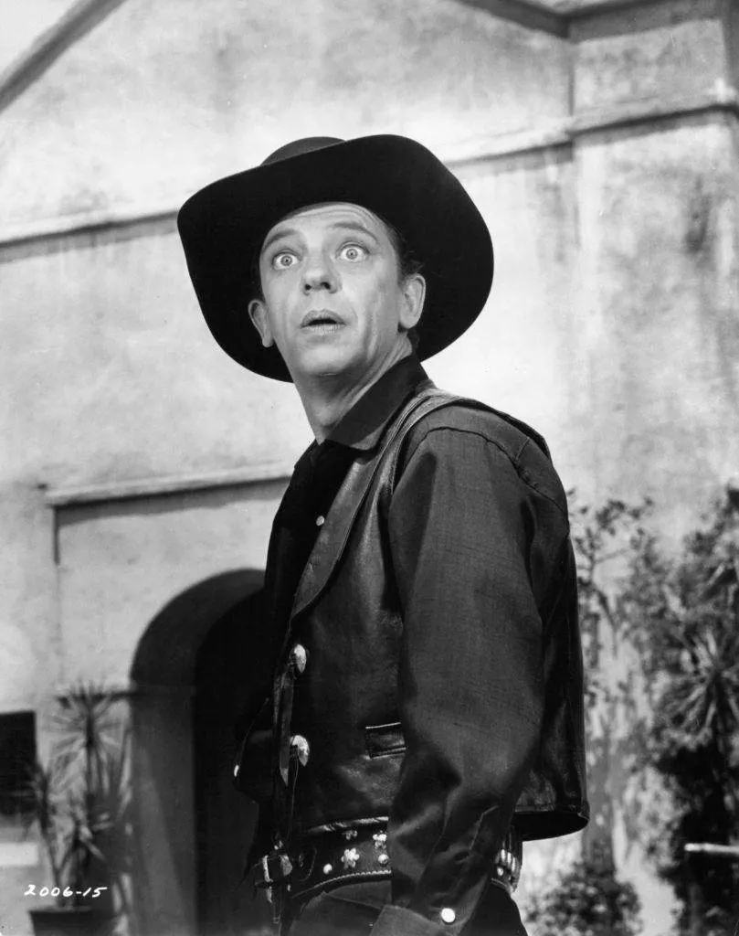 Don Knotts with his eyes wide open wearing western wear