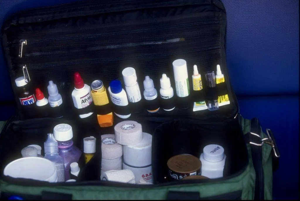 the inside of a first aid kit with bandages, lotions, and other medicine