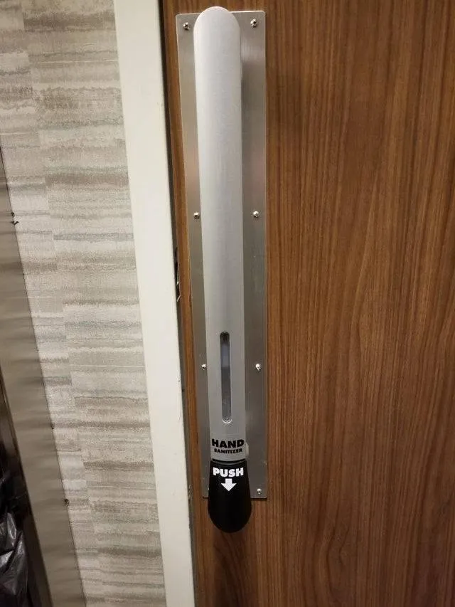 door with hand sanitizer attached to handle