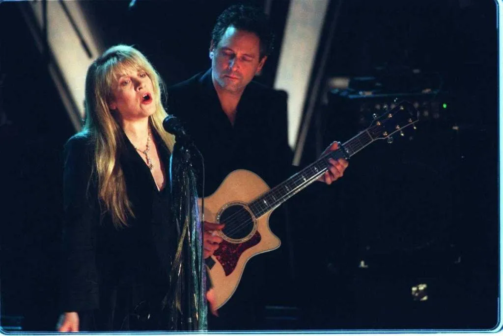 Stevie Nicks sings while bandmate Lindsey Buckingham looks on during a performance by Fleetwood Mac as the band is inducted into Rock & Roll's Hall of Fame