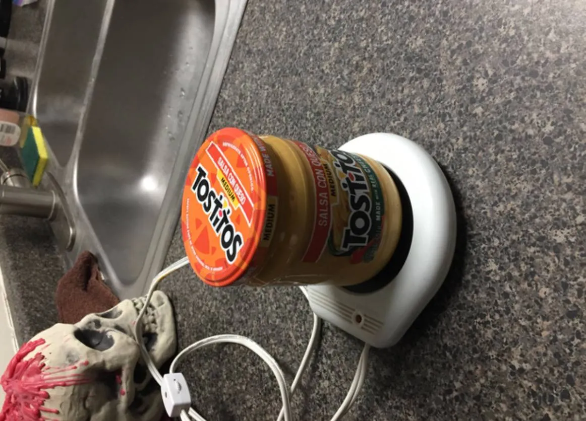 jar of queso dip on a small hotplate