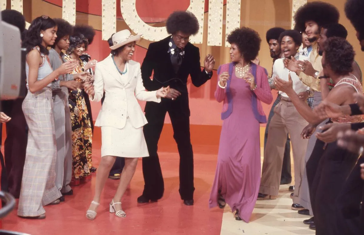 Don Cornelius dances down the Soul Train Line with Jean Terrell and Lynda Laurence of the Supremes on Soul Train.