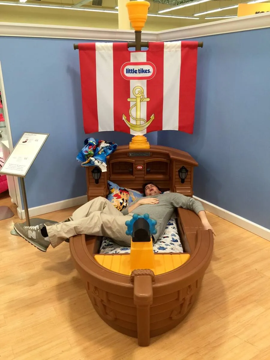 husband asleep in child's bed