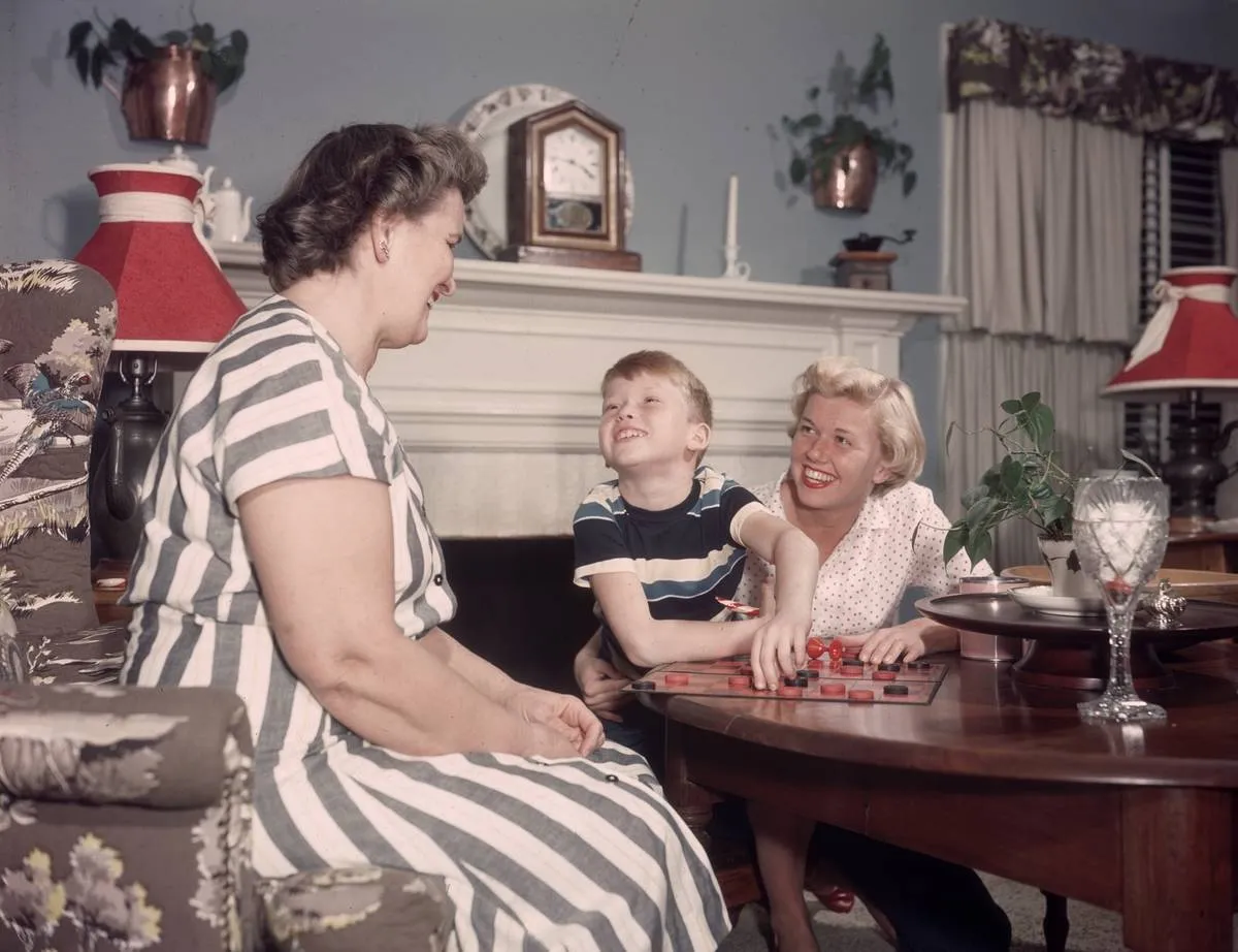 Doris Day and her son, Terry Melcher, play checkers with Day's mother.