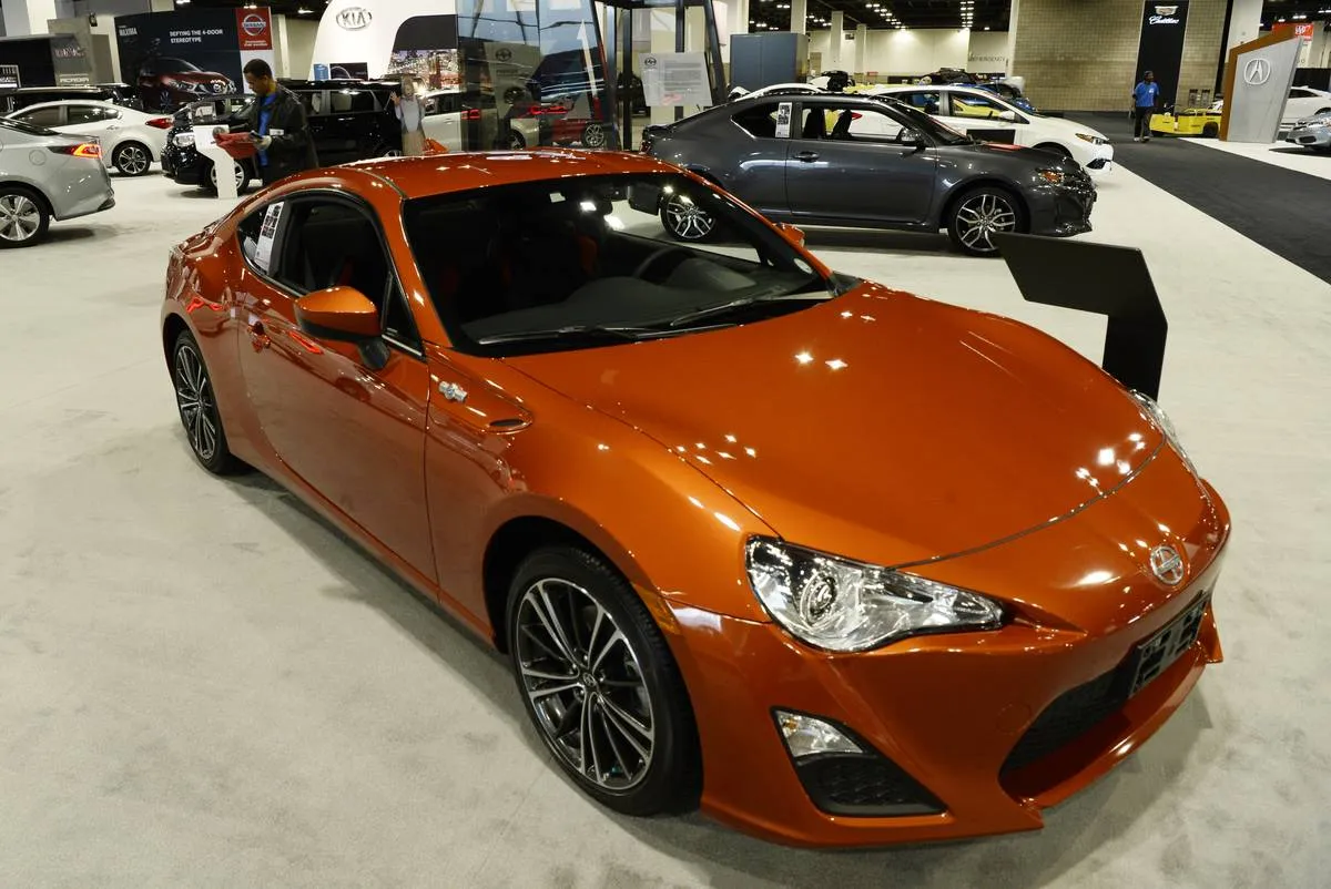 An orange Scion FR-S is displayed at the Denver Auto Show.
