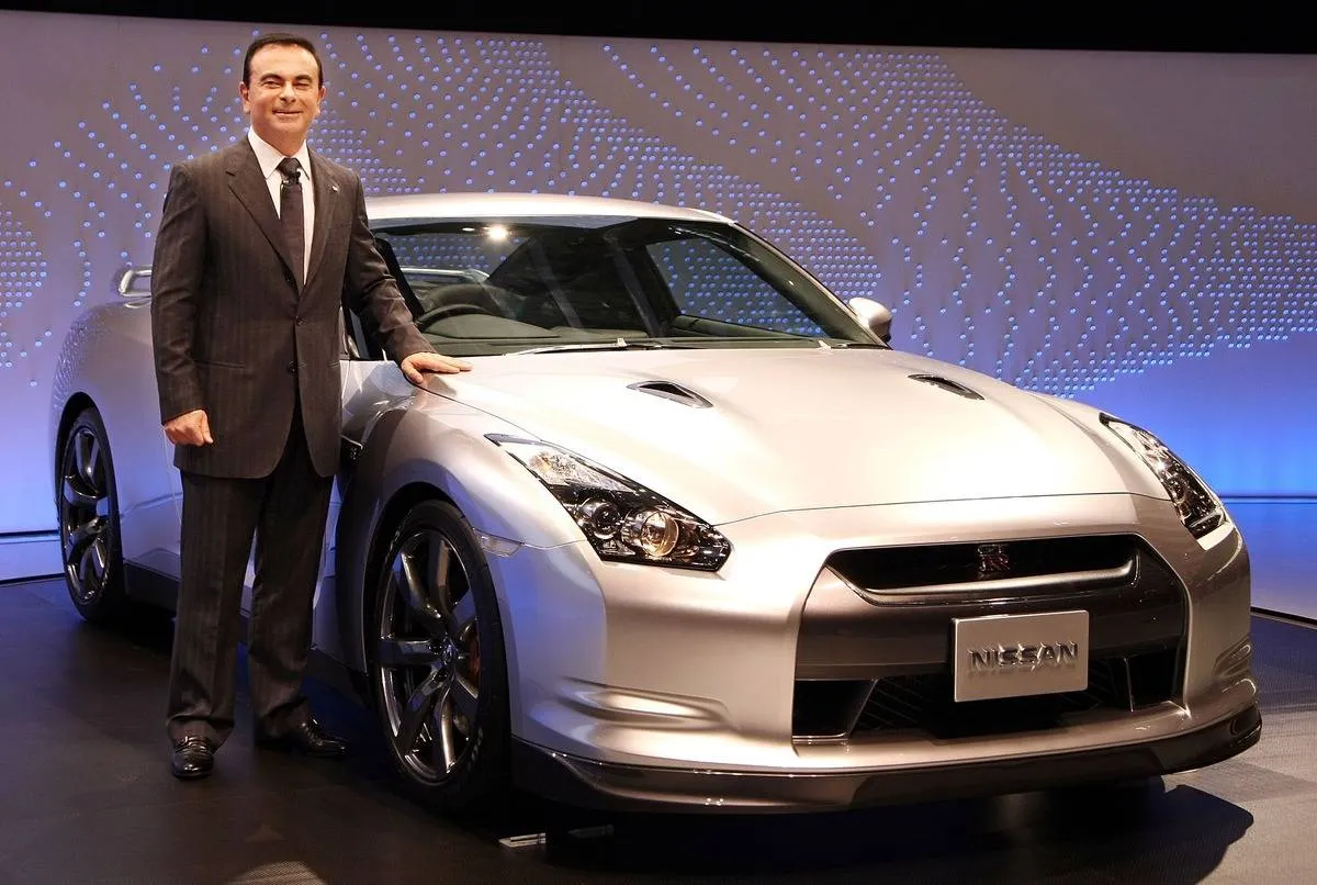 The CEO of Nissan poses next to the GT-R.