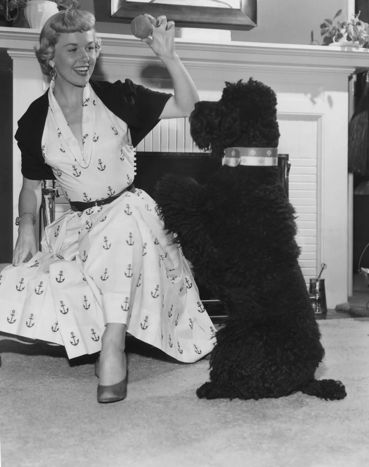 Doris Day plays fetch with a poodle.
