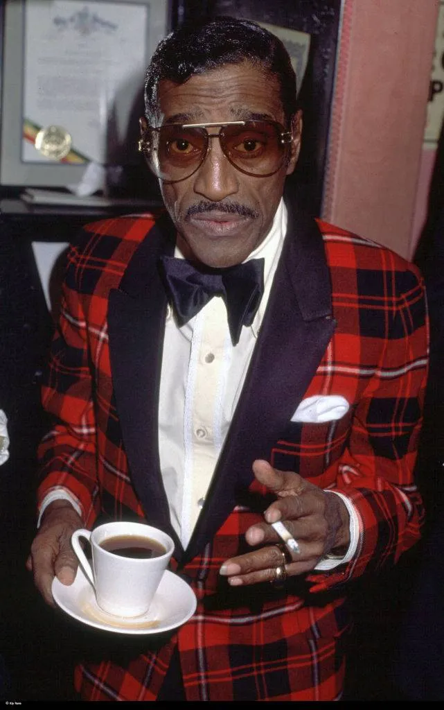 American singer, musician, dancer, actor, vaudevillian and comedian Sammy Davis Jr with cup of tea, circa 1985.