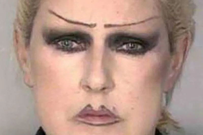 woman shows off penciled brows and makeup